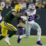 
              Dallas Cowboys running back Tony Pollard (20) attempts to escape tackle attempts as he runs the ball during the first half of an NFL football game against the Green Bay Packers, Sunday, Nov. 13, 2022, in Green Bay, Wis. (AP Photo/Matt Ludtke)
            