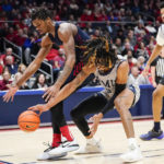 
              Dayton forward DaRon Holmes II, left, and Robert Morris forward Kahliel Spear, right, fight for a loose ball near the baseline during the second half of an NCAA college basketball game, Saturday, Nov. 19, 2022, in Dayton, Ohio. (AP Photo/Joshua A. Bickel)
            