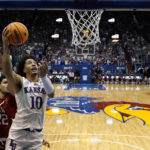 
              Kansas forward Jalen Wilson (10) gets past Southern Utah center Parsa Fallah (22) to put up a shot during the first half of an NCAA college basketball game Friday, Nov. 18, 2022, in Lawrence, Kan. (AP Photo/Charlie Riedel)
            