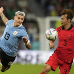 
              Uruguay's Guillermo Varela, left, duels for the ball with South Korea's Kim Jin-su during the World Cup group H soccer match between Uruguay and South Korea, at the Education City Stadium in Al Rayyan , Qatar, Thursday, Nov. 24, 2022. (AP Photo/Lee Jin-man)
            