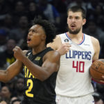 
              Utah Jazz guard Collin Sexton , left, celebrates after scoring as Los Angeles Clippers center Ivica Zubac stands in the background during the second half of an NBA basketball game Sunday, Nov. 6, 2022, in Los Angeles. (AP Photo/Mark J. Terrill)
            