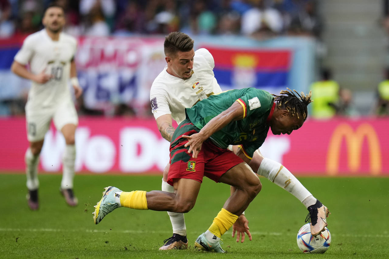 Serbia's Sergej Milinkovic-Savic, left, and Cameroon's Pierre Kunde battle for the ball during the ...