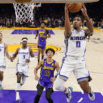 
              Sacramento Kings guard Malik Monk, right, shoots as Los Angeles Lakers guard Max Christie (10) watches along with other players during the first half of an NBA basketball game Friday, Nov. 11, 2022, in Los Angeles. (AP Photo/Mark J. Terrill)
            