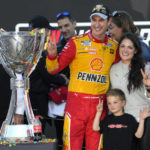 
              Joey Logano celebrates with his family after after winning a NASCAR Cup Series auto race and championship Sunday, Nov. 6, 2022, in Avondale, Ariz. (AP Photo/Rick Scuteri)
            