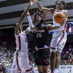 
              Alabama forward Brandon Miller, left, Jacksonville State forward Clarence "Monzy" Jackson (25) and Alabama forward Noah Clowney, right, chase a rebound during the first half of an NCAA college basketball game, Friday, Nov. 18, 2022, in Tuscaloosa, Ala. (AP Photo/Vasha Hunt)
            