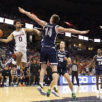 
              Virginia's Kihei Clark (0) passes the ball against Monmouth during the first half of an NCAA college basketball game in Charlottesville, Va., Friday, Nov. 11, 2022. (AP Photo/Mike Kropf)
            