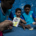 
              Students play with cards from the 2022 World Cup in Qatar before the announcement of the list of players from the Brazil national team who will compete in the competition, at the municipal school Paulo Reglus Neves Freire where the player Vinicius Jr. studied, in Sao Goncalo, Rio de Janeiro state, Brazil, Monday, Nov. 7, 2022. Four years ago teenager Vinicius Jr. took his first medal from a professional soccer tournament home, a place where drug gangs and vigilantes fight for control and children dribble past garbage on the streets. Today, Vinicius is a key figure on Brazil’s World Cup team. (AP Photo/Bruna Prado)
            