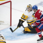 
              Montreal Canadiens' Sean Monahan (91) scores against Pittsburgh Penguins goaltender Tristan Jarry (35) during third-period NHL hockey game action in Montreal, Saturday, Nov. 12, 2022. (Graham Hughes/The Canadian Press via AP)
            