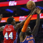 
              Philadelphia 76ers' Paul Reed, left, reaches for a rebound over New York Knicks' Julius Randle, right, during the second half of an NBA basketball game, Friday, Nov. 4, 2022, in Philadelphia. (AP Photo/Chris Szagola)
            