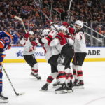 
              New Jersey Devils celebrate a goal as Edmonton Oilers' Brett Kulak (27) looks down during the third period of an NHL hockey game Thursday, Nov. 3, 2022, in Edmonton, Alberta. (Jason Franson/The Canadian Press via AP)
            