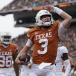 
              Texas quarterback Quinn Ewers (3) celebrates after scoring a touchdown against Baylor during the first half of an NCAA college football game in Austin, Texas, Friday, Nov. 25, 2022. (AP Photo/Eric Gay)
            