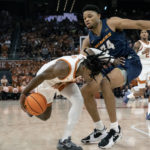 
              Texas guard Marcus Carr, left, drives past UTEP forward Kevin Kalu during the first half an NCAA college basketball game Monday, Nov. 7, 2022, in Austin, Texas. (AP Photo/Michael Thomas)
            