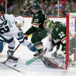 
              Minnesota Wild goaltender Filip Gustavsson (32) stops a shot by San Jose Sharks right wing Kevin Labanc (62) with Wild defenseman Jonas Brodin (25) and center Sam Steel (13) assisting in the second period of an NHL hockey game Sunday, Nov. 13, 2022, in St. Paul, Minn. (AP Photo/Andy Clayton-King)
            