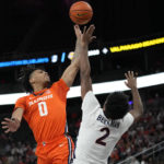 
              Virginia's Reece Beekman (2) fouls Illinois' Terrence Shannon Jr. (0) during the first half of an NCAA college basketball game Sunday, Nov. 20, 2022, in Las Vegas. (AP Photo/John Locher)
            