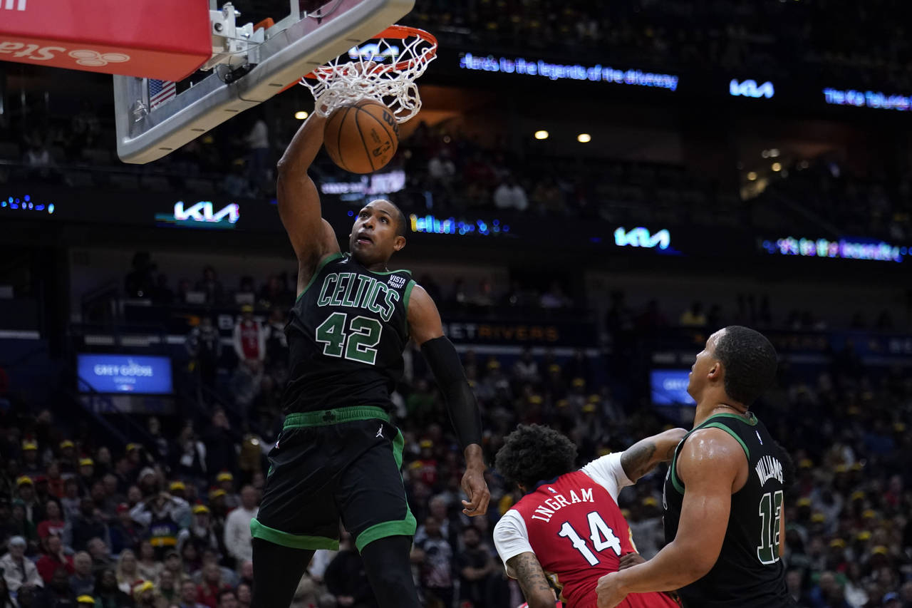 Boston Celtics center Al Horford (42) slam dunks over New Orleans Pelicans forward Brandon Ingram (...