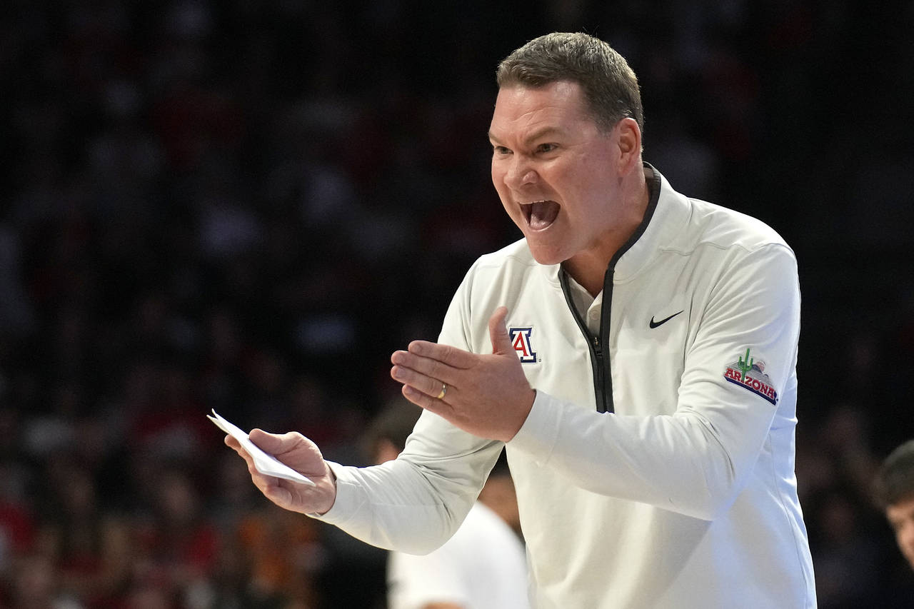 Arizona head coach Tommy Lloyd reacts after a foul call during the first half of an NCAA college ba...