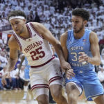 
              CORRECTS CITY TO BLOOMINGTON, INSTEAD OF INDIANAPOLIS - Indiana forward Race Thompson (25) and North Carolina forward Pete Nance (32) chase a loose ball during the first half of an NCAA college basketball game in Bloomington, Ind., Wednesday, Nov. 30, 2022. (AP Photo/Darron Cummings)
            