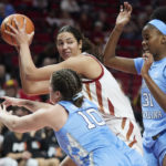 
              Iowa State center Stephanie Soares looks to pass away from North Carolina forward Anya Poole, right, and guard Eva Hodgson during the first half of an NCAA college basketball game in the Phil Knight Invitational in Portland, Ore., Sunday, Nov. 27, 2022. (AP Photo/Craig Mitchelldyer)
            
