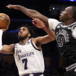 
              Los Angeles Lakers guard Troy Brown Jr., left, shoots under pressure from San Antonio Spurs forward Gorgui Dieng during the first half of an NBA basketball game Sunday, Nov. 20, 2022 in Los Angeles. (AP Photo/Ringo H.W. Chiu)
            