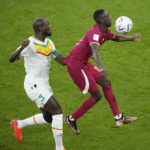 
              Senegal's Kalidou Koulibaly and Qatar's Almoez Ali battle for possession during the World Cup group A soccer match between Qatar and Senegal, at the Al Thumama Stadium in Doha, Qatar, Friday, Nov. 25, 2022. (AP Photo/Ariel Schalit)
            