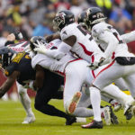 
              Washington Commanders running back Brian Robinson Jr. (8) is taken down by Atlanta Falcons linebacker Lorenzo Carter (9) and other members of the Atlanta Falcons during the first half of an NFL football game, Sunday, Nov. 27, 2022, in Landover, Md. (AP Photo/Patrick Semansky)
            