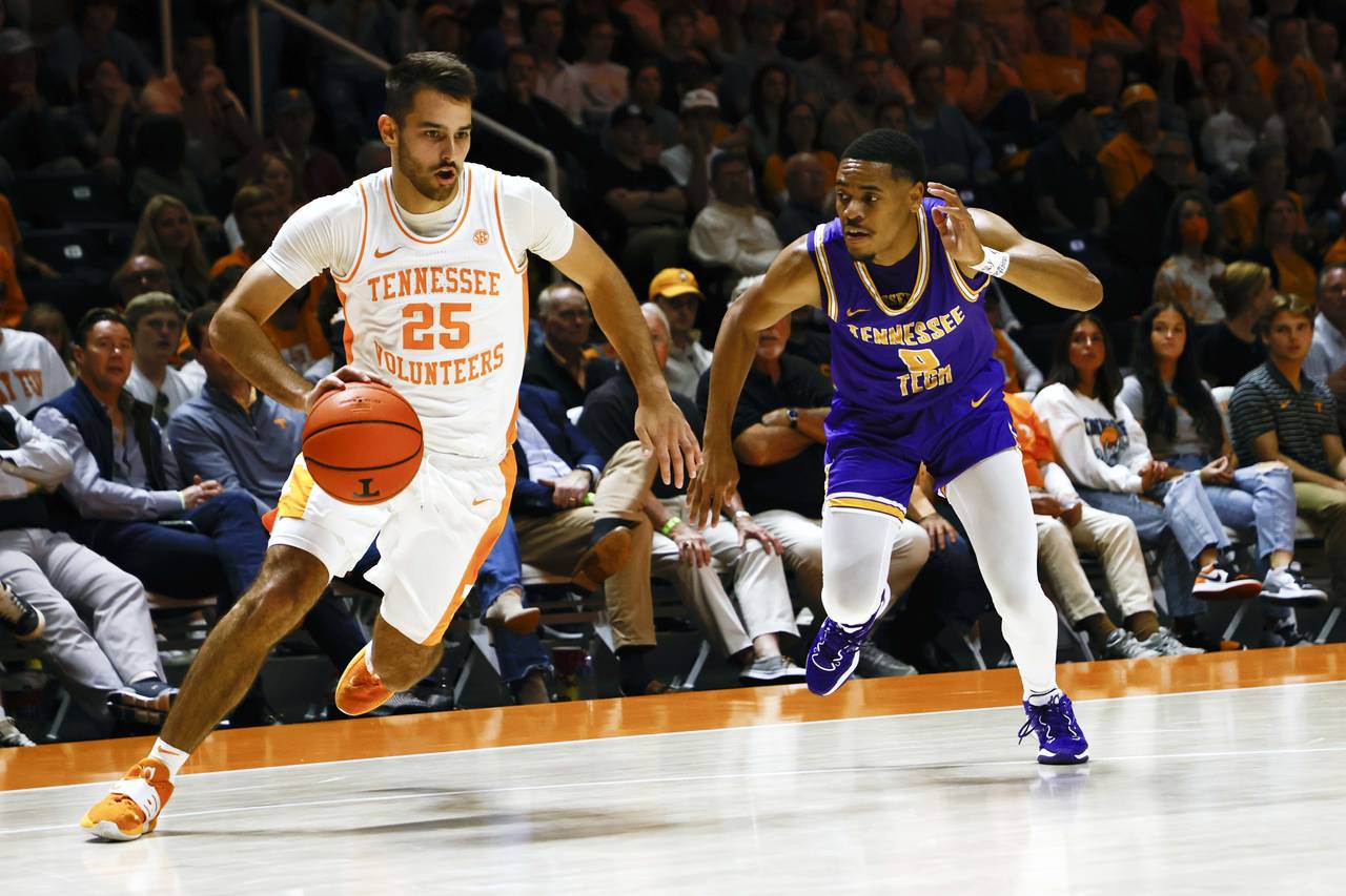 Tennessee guard Santiago Vescovi (25) drives past Tennessee Tech guard Ty Perry (0) during the firs...