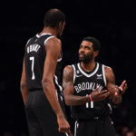 
              Brooklyn Nets guard Kyrie Irving  talks to forward Kevin Durant (7) during the first half of an NBA basketball game against the Orlando Magic, Monday, Nov. 28, 2022, in New York. (AP Photo/Julia Nikhinson)
            