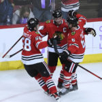 
              Chicago Blackhawks center Jonathan Toews (19) celebrates with right wing MacKenzie Entwistle (58) and defenseman Jake McCabe (6) after he scored against the Los Angeles Kings during the overtime in an NHL hockey game Thursday, Nov. 3, 2022, in Chicago. (AP Photo/Matt Marton)
            
