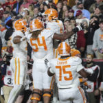
              Tennessee wide receiver Bru McCoy (15), offensive lineman Gerald Mincey (54) and offensive lineman Jerome Carvin (75) celebrate with wide receiver Cedric Tillman (4) after his touchdown during the first half of an NCAA college football game against South Carolina on Saturday, Nov. 19, 2022, in Columbia, S.C. (AP Photo/Artie Walker Jr.)
            