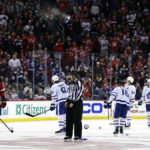 
              New Jersey Devils defenseman Ryan Graves (33) and Toronto Maple Leafs' John Tavares (91), Mitchell Marner (16) and Auston Matthews (34) avoid flying objects during the third period of an NHL hockey game Wednesday, Nov. 23, 2022, in Newark, N.J. Fans were reacting to a New Jersey Devils goal being disallowed for the third time. The Maple Leafs won 2-1. (AP Photo/Adam Hunger)
            
