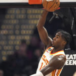 
              Atlanta Hawks forward AJ Griffin dunks during the first half of an NBA basketball game against the Cleveland Cavaliers, Monday, Nov. 21, 2022, in Cleveland. (AP Photo/Nick Cammett)
            