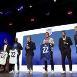 
              United States soccer players DeAndre Yedlin, Shaq Moore, Aaron Long and Walker Zimmerman hold up jerseys, Wednesday, Nov. 9, 2022, in New York, after being introduced announced as defenders on the U.S. men's national soccer roster for the upcoming World Cup in Qatar. (AP Photo/Julia Nikhinson)
            