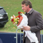 
              In this image from video, Virginia Gov. Glenn Youngkin brings flowers to a memorial service at the University of Virginia, Tuesday, Nov. 15, 2022, in Charlottesville, Va. A University of Virginia student and former member of the school's football team fatally shot three current players as they returned from a field trip, authorities said, setting off panic and a 12-hour lockdown of the campus until the suspect was captured Monday. (AP Photo/Nathan Ellgren)
            