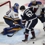 
              Colorado Avalanche left wing Artturi Lehkonen, center, loses control of the puck while driving to the net as St. Louis Blues goaltender Jordan Binnington, left, and defenseman Colton Parayko, top right, cover in the first period of an NHL hockey game Monday, Nov. 14, 2022, in Denver. (AP Photo/David Zalubowski)
            