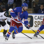
              New York Rangers left wing Alexis Lafreniere skates with the puck as Arizona Coyotes right wing Dylan Guenther (11) pursues during the first period of an NHL hockey game Sunday, Nov. 13, 2022, in New York. (AP Photo/John Munson)
            