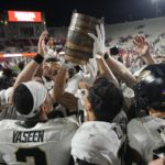 
              The Purdue football team celebrates with the Old Oaken Bucket after defeating Indiana in an NCAA college football game, Saturday, Nov. 26, 2022, in Bloomington, Ind. (AP Photo/Darron Cummings)
            
