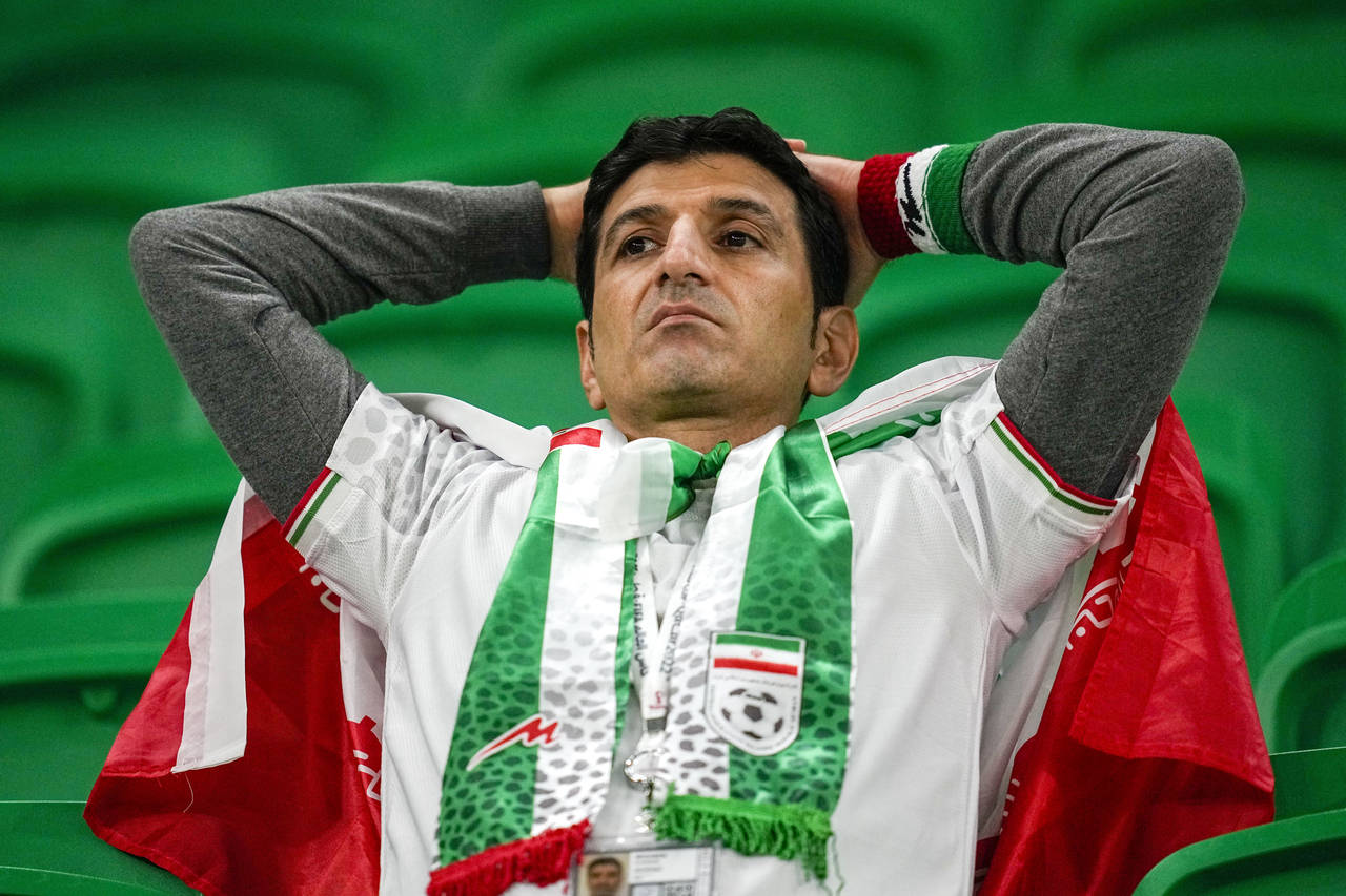 Iran's soccer team fan looks on at the end of the World Cup group B soccer match between Iran and t...