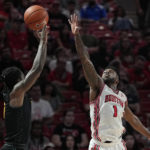 
              Norfolk State guard Christian Ings misses a shot under pressure from Houston guard Jamal Shead (1) during the first half of an NCAA college basketball game, Tuesday, Nov. 29, 2022, in Houston. (AP Photo/Kevin M. Cox)
            