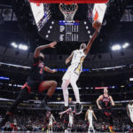 
              New Orleans Pelicans forward Herbert Jones, right, drives to the basket against Chicago Bulls center Andre Drummond during the second half of an NBA basketball game Wednesday, Nov. 9, 2022, in Chicago. The Pelicans won 115-111.(AP Photo/Nam Y. Huh)
            