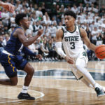 
              Michigan State's Jaden Akins, right, drives against Northern Arizona's Jalen Cone during the first half of an NCAA college basketball game Monday, Nov. 7, 2022, in East Lansing, Mich. (AP Photo/Al Goldis)
            