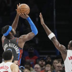 
              Oklahoma City Thunder guard Shai Gilgeous-Alexander, top left, shoots in front of Toronto Raptors guard Fred VanVleet, bottom left, and forward O.G. Anunoby (3) in the first half of an NBA basketball game Friday, Nov. 11, 2022, in Oklahoma City. (AP Photo/Sue Ogrocki)
            