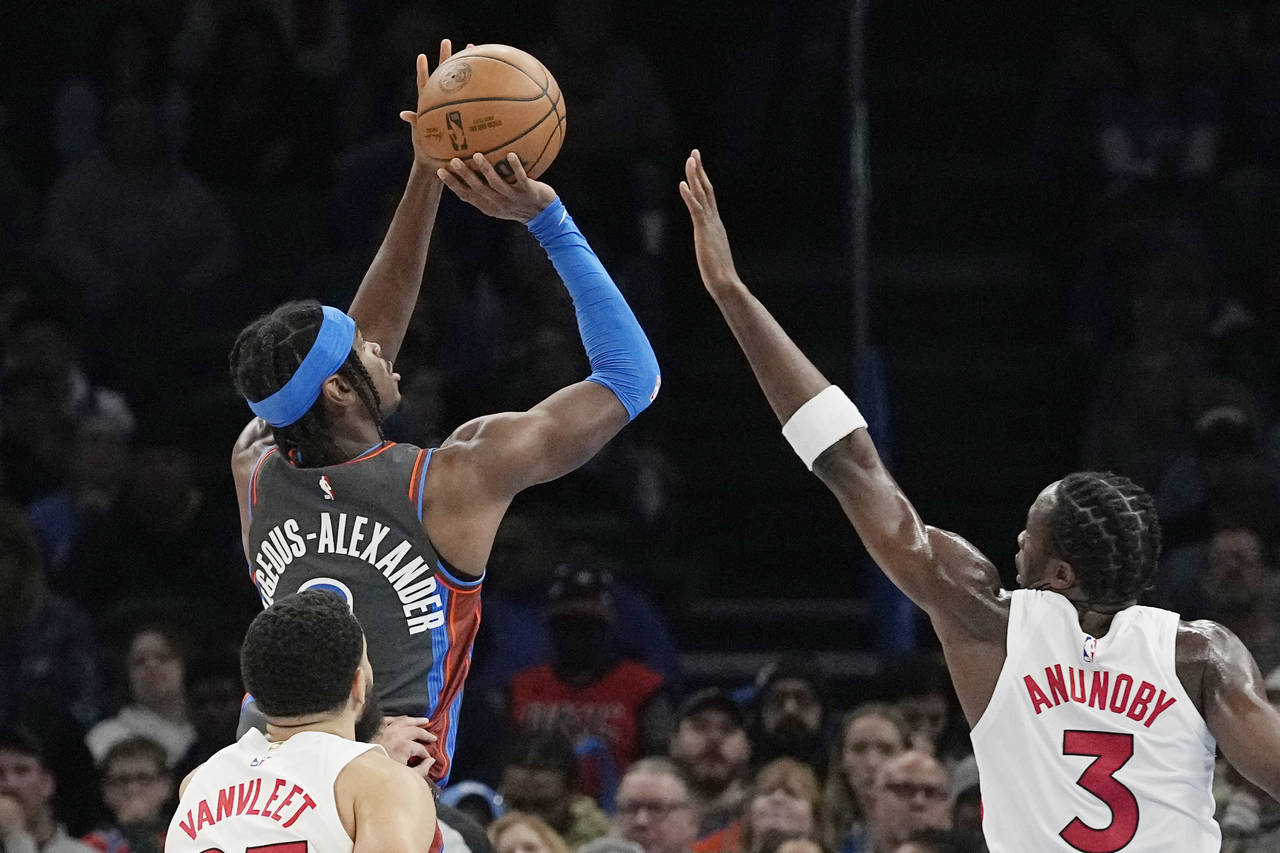Oklahoma City Thunder guard Shai Gilgeous-Alexander, top left, shoots in front of Toronto Raptors g...