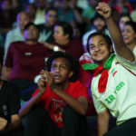 
              Fans react as they watch the World Cup, group A soccer match between Qatar and Ecuador at the fan zone in Doha, Sunday, Nov. 20, 2022. (AP Photo/Petr David Josek)
            
