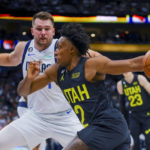 
              Utah Jazz guard Collin Sexton, front, drives to the basket against Dallas Mavericks guard Luka Doncic during the first half of an NBA basketball game Wednesday, Nov. 2, 2022, in Dallas. (AP Photo/Gareth Patterson)
            