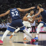 
              Milwaukee Bucks forward Giannis Antetokounmpo, center, works toward the basket against Minnesota Timberwolves center Karl-Anthony Towns (32) and center Rudy Gobert, right, during the first half of an NBA basketball game, Friday, Nov. 4, 2022, in Minneapolis. (AP Photo/Abbie Parr)
            