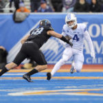 
              BYU running back Lopini Katoa (4) cuts back with the ball while trying to avoid a tackle-attempt by Boise State linebacker Ty Tanner (58) in the first half of an NCAA college football game, Saturday, Nov. 5, 2022, in Boise, Idaho. (AP Photo/Steve Conner)
            