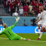 
              Tunisia's Issam Jebali, right, challenges Denmark's goalkeeper Kasper Schmeichel during the World Cup group D soccer match between Denmark and Tunisia, at the Education City Stadium in Al Rayyan, Qatar, Tuesday, Nov. 22, 2022. (AP Photo/Manu Fernandez)
            