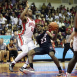 
              Texas Tech guard De'Vion Harmon (23) tries to get to the net under Ohio State forward Brice Sensabaugh (10) during the second half of an NCAA college basketball game, Wednesday, Nov. 23, 2022, in Lahaina, Hawaii. (AP Photo/Marco Garcia)
            