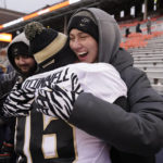 
              Purdue quarterback Aidan O'Connell is hugged by his wife Jael after Purdue defeated Illinois 31-24 in an NCAA college football game Saturday, Nov. 12, 2022, in Champaign, Ill. (AP Photo/Charles Rex Arbogast)
            