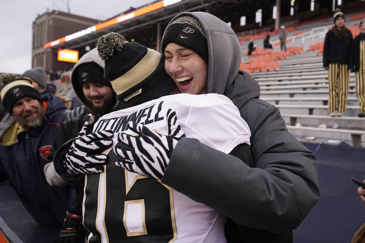 Purdue quarterback Aidan O'Connell is hugged by his wife Jael after Purdue defeated Illinois 31-24 ...